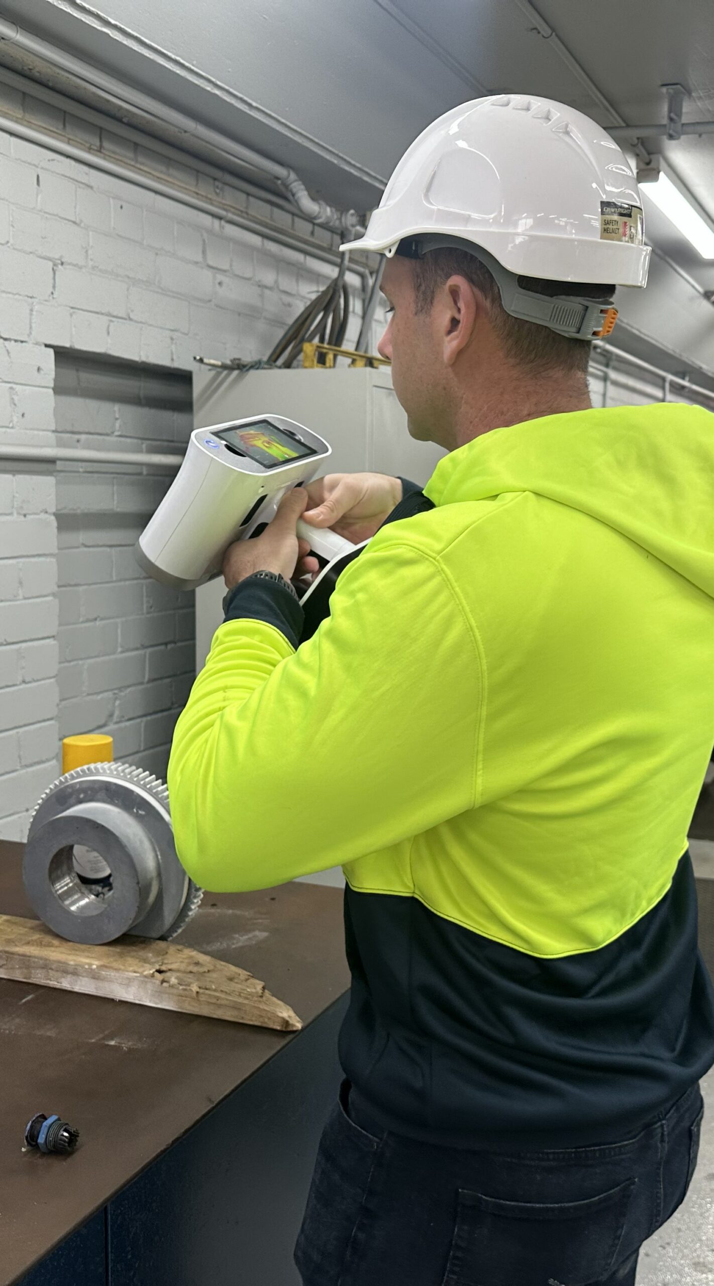 Engineer performing 3D laser scanning of industrial equipment for reverse engineering and digital asset capture.